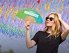 Woman dancing with a personalised promotional fan